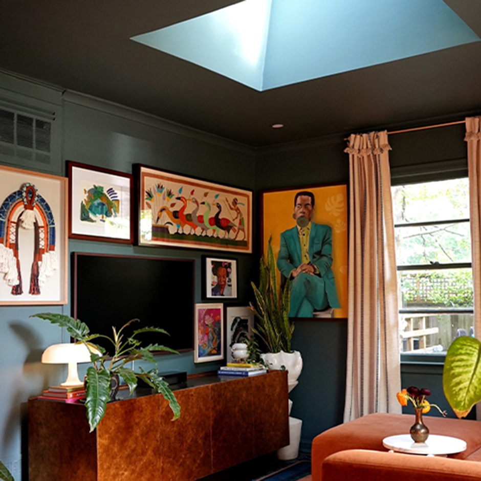 David renovated his living room and added a skylight above the center of the room. The room features dark blue walls and ceiling as well as cozy warm colored accents. It brings in balanced natural light to a darker space—and adds a focal point to the room. 
